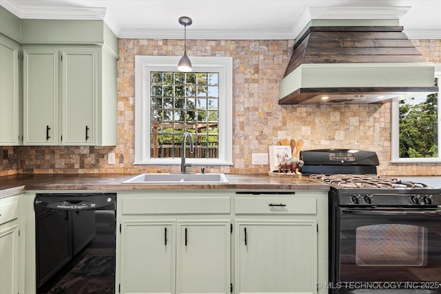 kitchen with dark countertops, decorative light fixtures, black appliances, premium range hood, and a sink