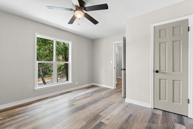 2936 Ridge Rd, Bartlesville, OK 74006 - empty room with wood finished floors and a ceiling fan