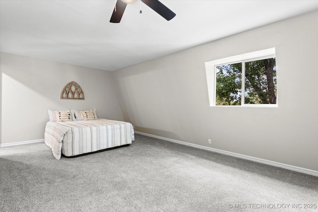 unfurnished bedroom with ceiling fan, carpet flooring, and baseboards