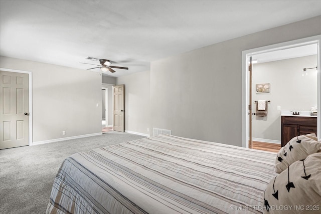 bedroom featuring visible vents, a ceiling fan, light carpet, ensuite bath, and baseboards