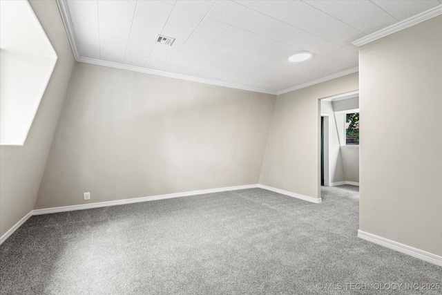 carpeted empty room with ornamental molding, visible vents, and baseboards