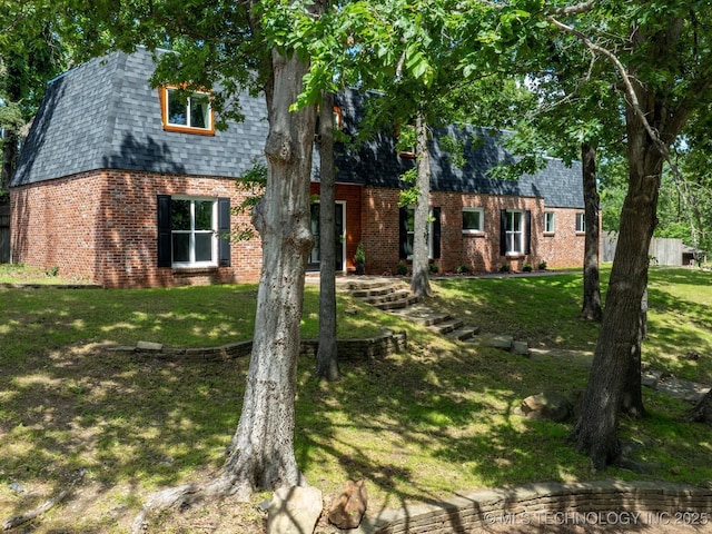 2936 Ridge Rd, Bartlesville, OK 74006 - view of front of house featuring brick siding, a front yard, and roof with shingles
