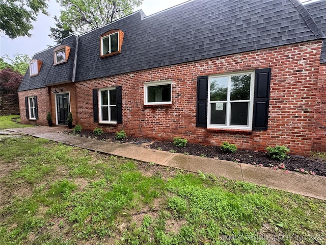 2936 Ridge Rd, Bartlesville, OK 74006 - view of home's exterior with roof with shingles, mansard roof, and brick siding