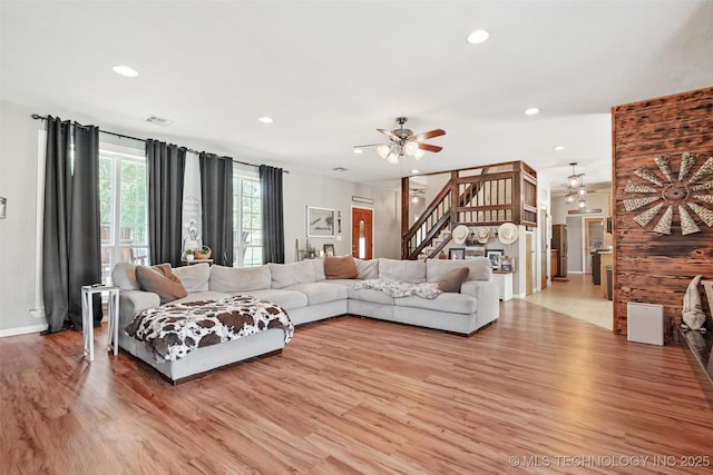 living room with ceiling fan and light hardwood / wood-style flooring