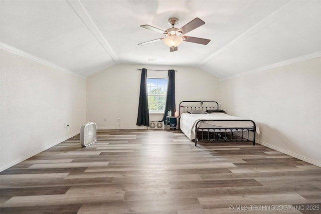 bedroom with hardwood / wood-style flooring, ceiling fan, and lofted ceiling