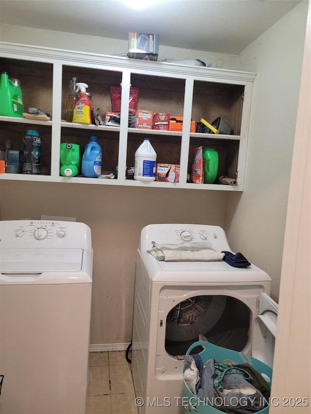 laundry room featuring light tile patterned floors and washer and clothes dryer