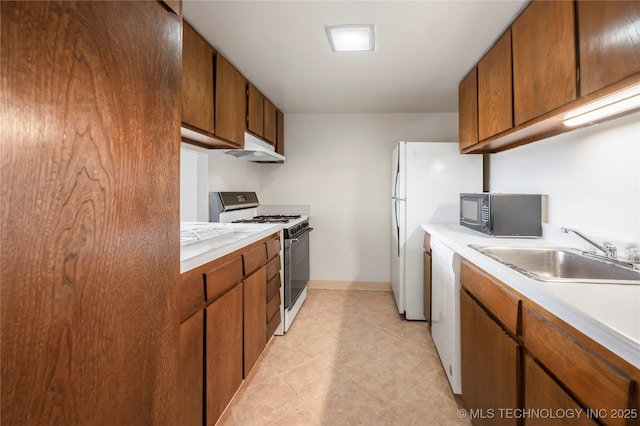 kitchen featuring sink and white appliances