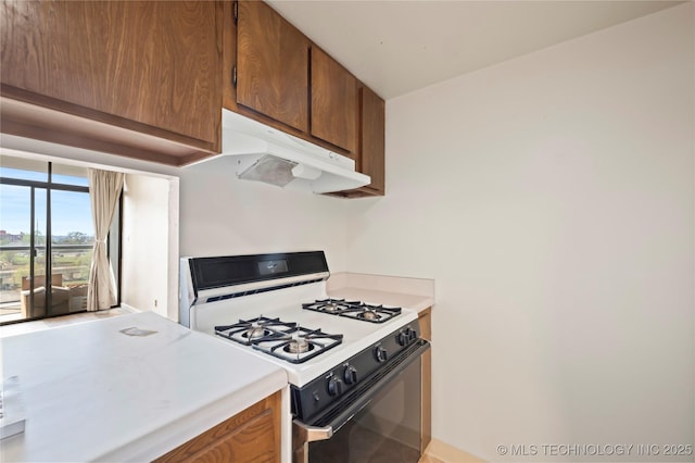 kitchen featuring white range with gas cooktop