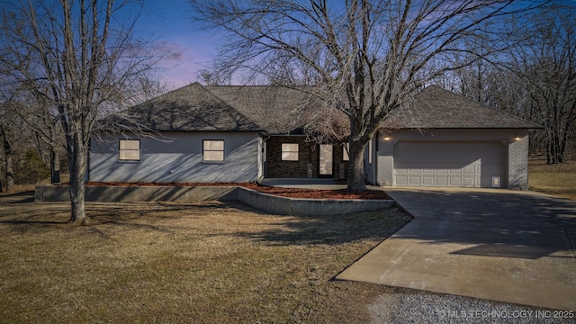 view of front of property with a garage and a yard