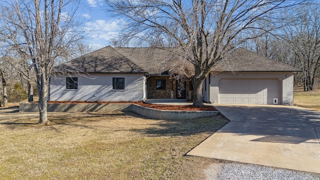 view of front of property featuring a garage and a front lawn