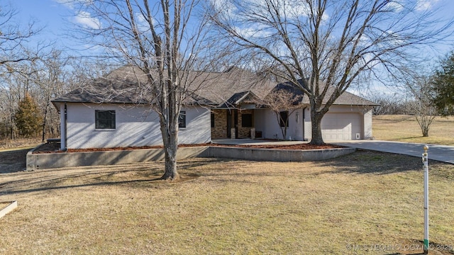 ranch-style house with a garage and a front yard