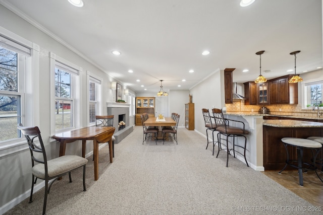 dining space featuring ornamental molding and sink