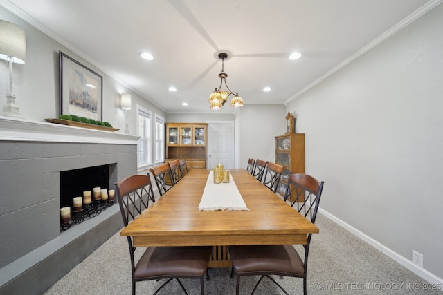 carpeted dining space with crown molding and a chandelier