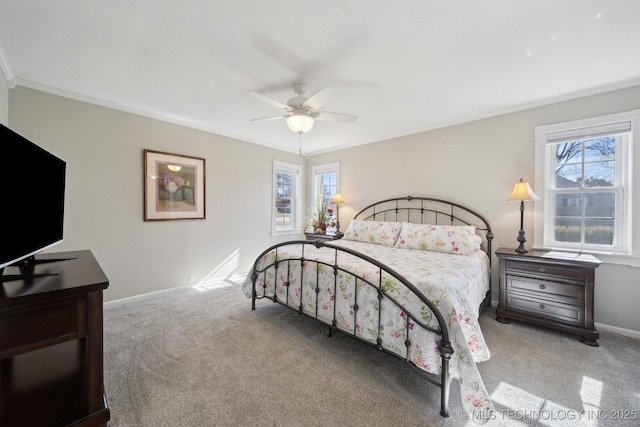 carpeted bedroom with crown molding and ceiling fan