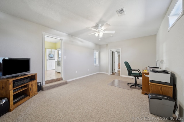 carpeted office space featuring a textured ceiling and ceiling fan