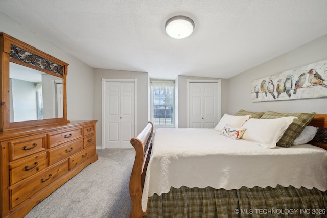 bedroom featuring carpet floors and a textured ceiling