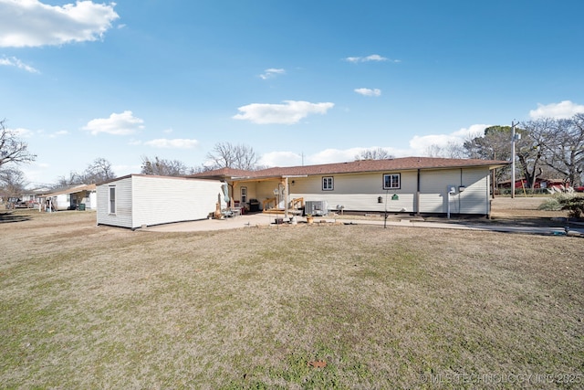 back of house with a yard and a patio