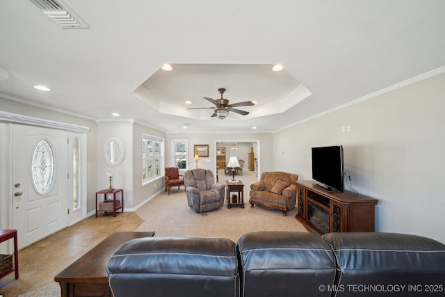 living room with crown molding, a raised ceiling, and ceiling fan