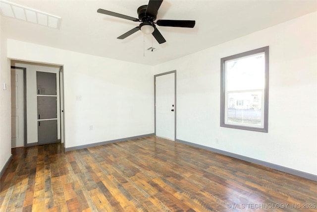 empty room featuring ceiling fan and dark hardwood / wood-style floors