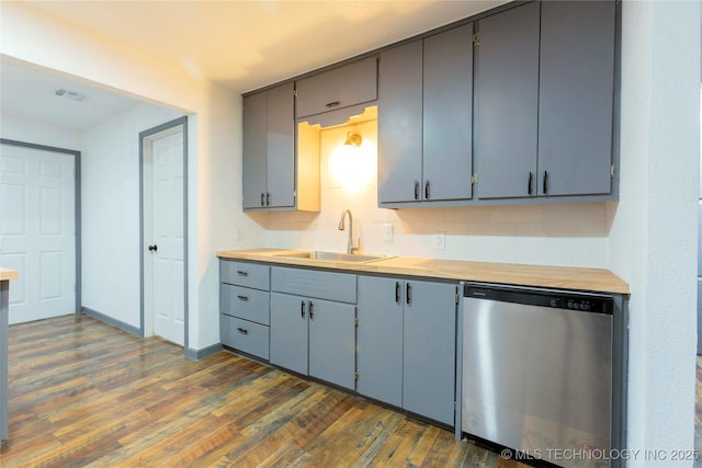 kitchen featuring dark hardwood / wood-style flooring, sink, gray cabinetry, and dishwasher