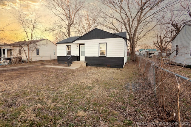 view of back house at dusk