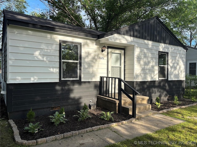 view of front of home featuring board and batten siding and crawl space