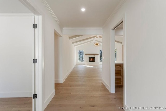 hall featuring lofted ceiling with beams, ornamental molding, and light hardwood / wood-style flooring