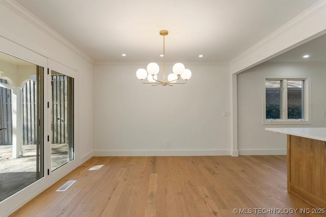 unfurnished dining area featuring a healthy amount of sunlight, crown molding, light hardwood / wood-style floors, and a chandelier