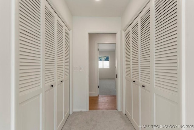 hallway featuring light carpet