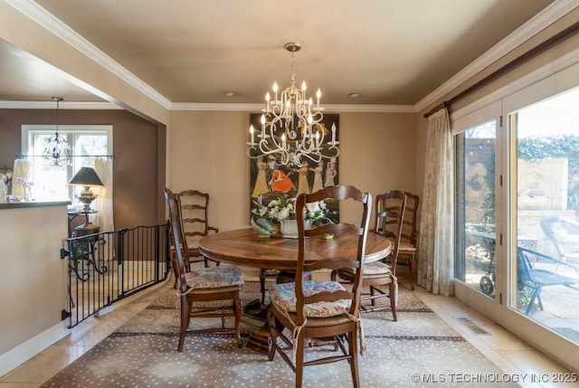 dining space with a notable chandelier, light tile patterned floors, a wealth of natural light, and ornamental molding