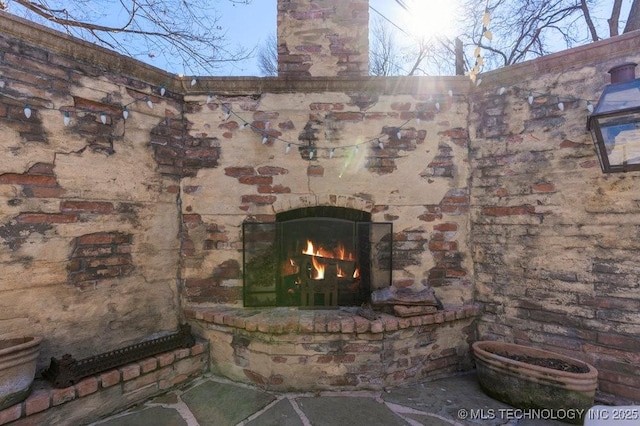 details featuring an outdoor brick fireplace