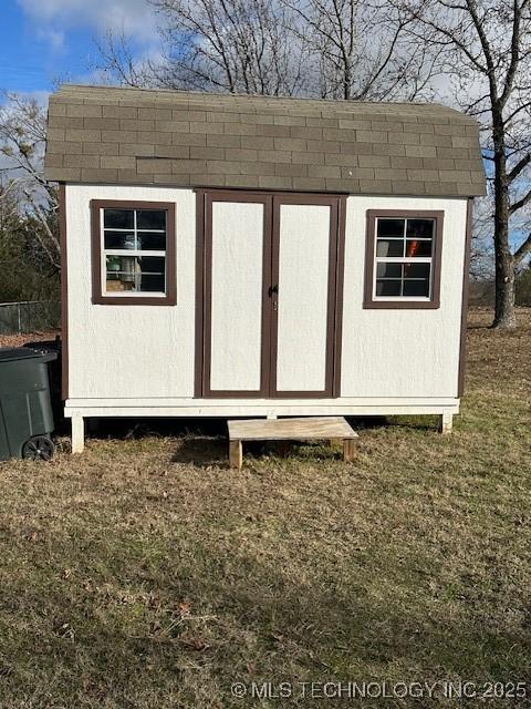 view of outbuilding featuring a lawn