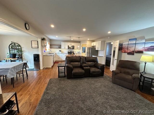 living room with sink and light hardwood / wood-style flooring