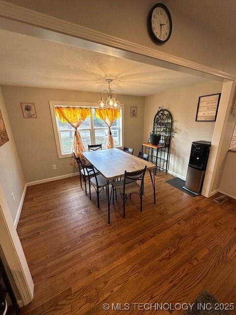 dining area featuring an inviting chandelier and dark hardwood / wood-style floors