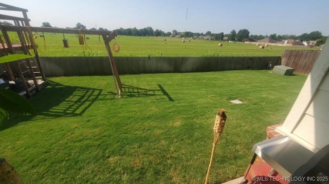 view of yard featuring a fenced backyard and a rural view