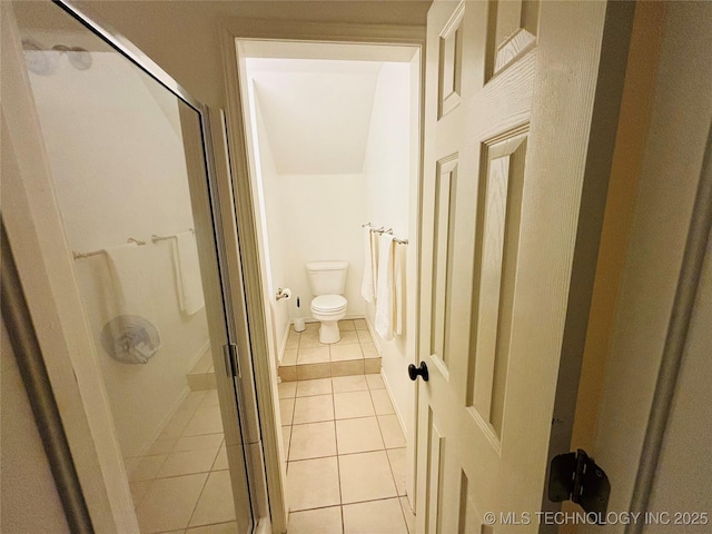 full bath with tile patterned flooring, a shower stall, and toilet