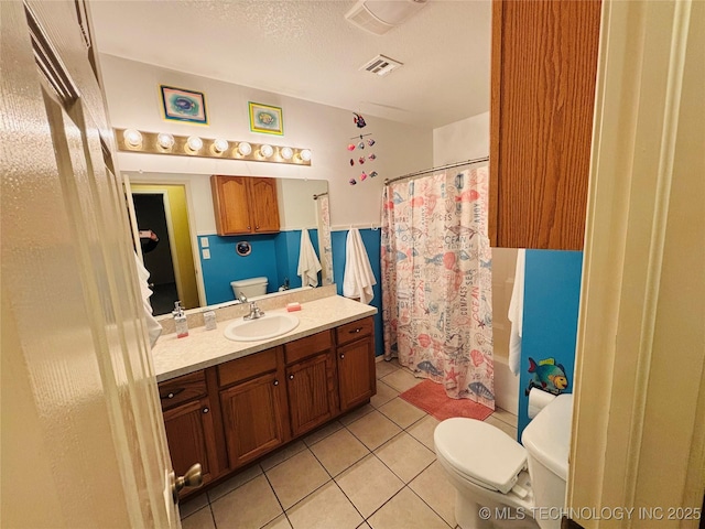 full bath featuring visible vents, vanity, toilet, and tile patterned floors