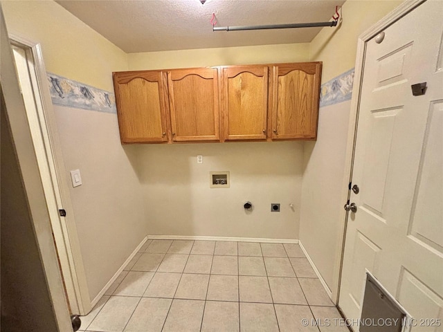 clothes washing area featuring washer hookup, light tile patterned floors, cabinet space, hookup for an electric dryer, and baseboards