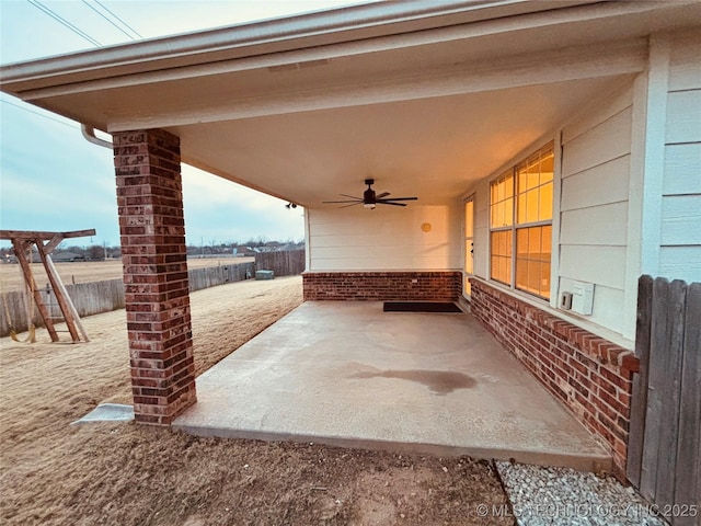 view of patio / terrace with fence and a ceiling fan