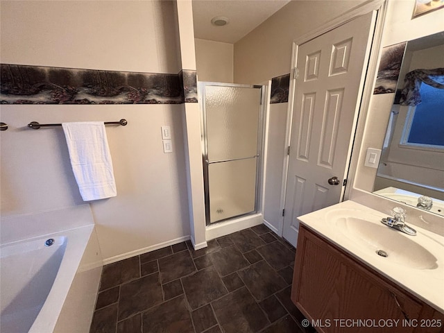 full bathroom featuring a stall shower, vanity, baseboards, and a bath