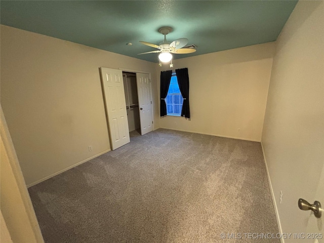 unfurnished bedroom with a ceiling fan, carpet, baseboards, and a closet