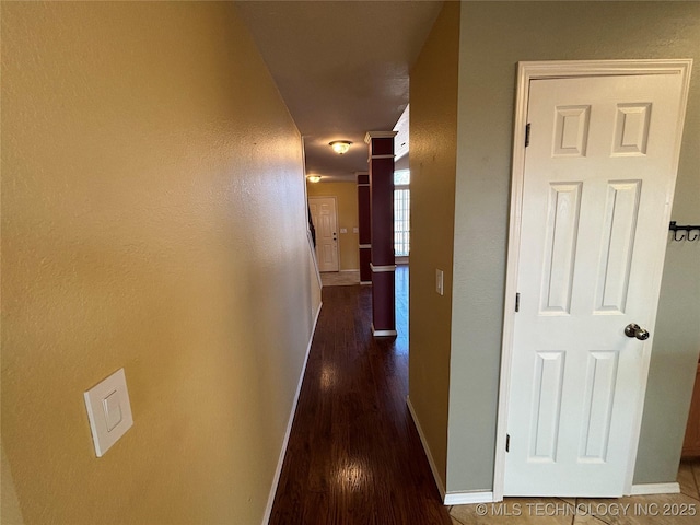 hall featuring wood finished floors and baseboards