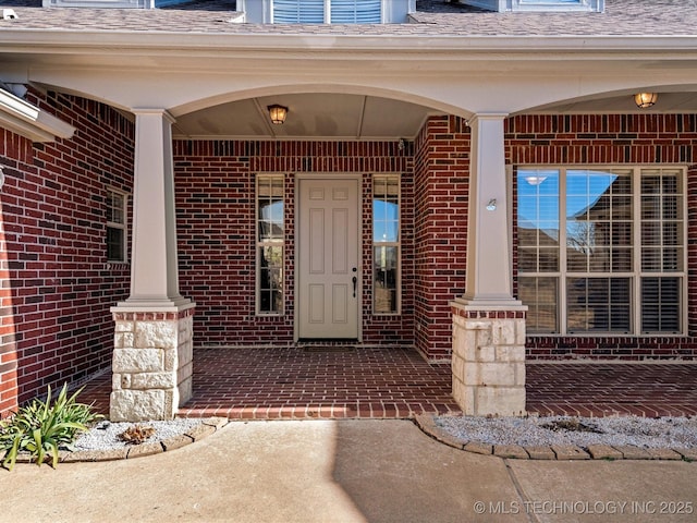 view of exterior entry with a porch