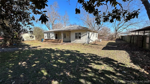 rear view of house with a yard