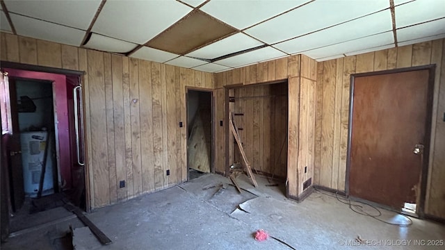 miscellaneous room with a drop ceiling and electric water heater