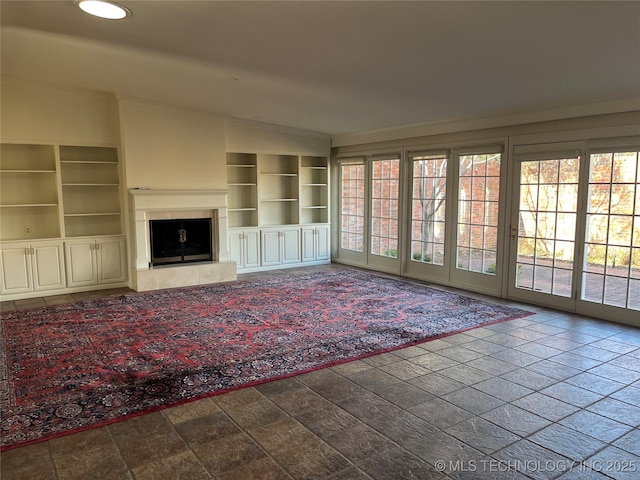 unfurnished living room with lofted ceiling and plenty of natural light