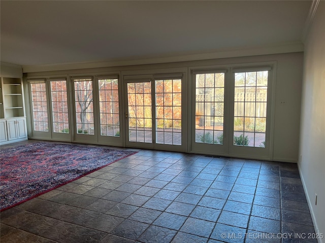 doorway with crown molding and built in features