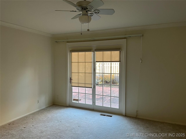 carpeted spare room featuring crown molding and ceiling fan