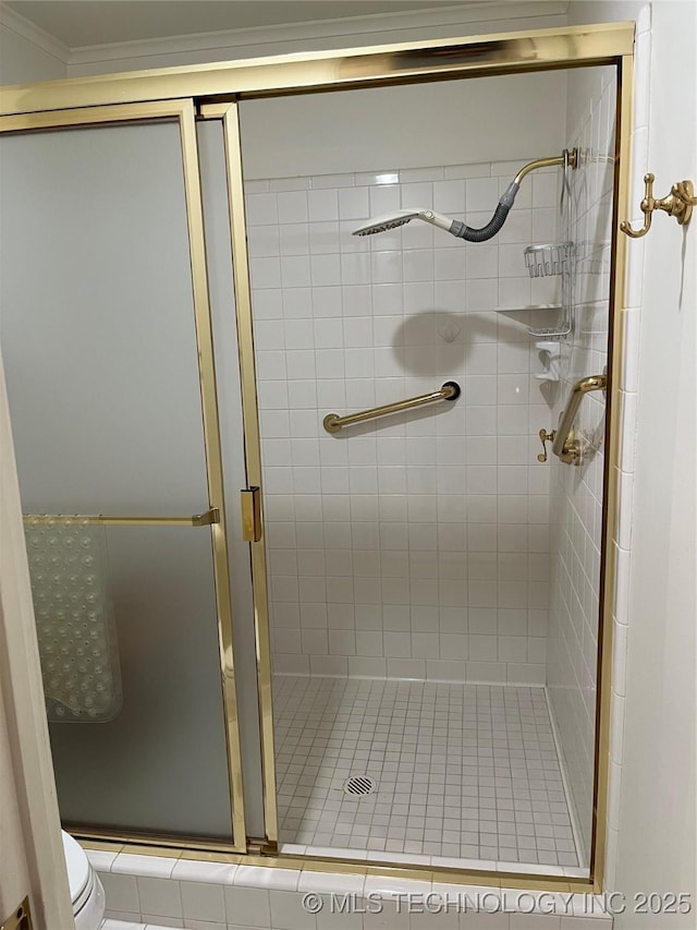 bathroom with toilet and a shower with shower door