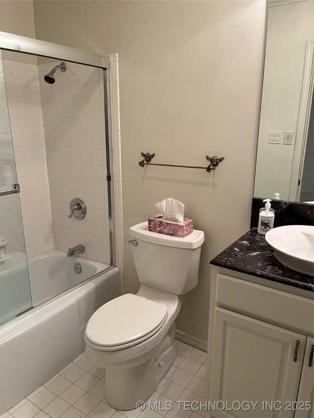 full bathroom with tile patterned flooring, vanity, bath / shower combo with glass door, and toilet